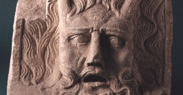 Ein in Stein gemeißeltes Gesicht mit zwei Hörnern, das den personifizierten Rhein darstellt